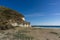 Small secluded sand beach framed by grassy hills on the Mediterranean coast of Andalusia near Cabo de Gata