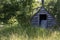 Small shed in field at edge forest edge