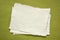 small sheet of blank white Khadi paper against green paper