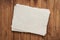 small sheet of blank white rag paper against rustic wood background