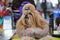 Small Shih Tzu dog getting groomed at dog show contest