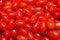 Small shiny tomato for red background