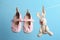 Small shoes and toy bunny hanging on washing line. Baby accessories