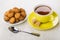 Small shortbread cookies in saucer and tea in cup, sugar