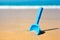 Small shovel in the sand on the beach