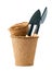 Small shovels in a peat pot for working in the garden isolated