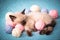 A small Siamese kitten sleeps in knitted balls of skeins of threads on a blue plaid