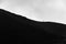 Small silhouette of men climbing on the edge of Etna volcano crater