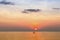 Small silhouettes of couple on the boards in the sea during sunset in the Sea.