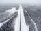 Small single car standing roadside in wintry road at blizzard, aerial view at straight northern route. Karelia, Russia