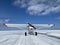 Small single engine airplane sits on an ice landing strip on a northern Minnesota lake