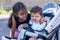 A small sister with her baby boy brother in a wheelchair