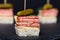Small snacks canape with salami, cheese and pickle on skewer on