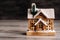 Small snow-covered Christmas house on the floor of the house.Winter house decorative