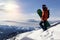 Small snowboarder on blue sky backdrop.