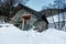 Small snowman in front of stone hut. Winter in El Tarter village.