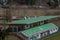 Small spectator stand of a soccer field with green seats.