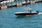 A small sport fishing boat black with white trim cruising on the florida intra-coastal waterway off Miami Beach.Small black fishi