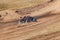 A small sports blurred buggy on a rally competition track during weekend training on a warm summer day