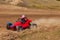 A small sports blurred buggy on a rally competition track during weekend training on a warm summer day