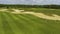 Small sportsmen running on golf course in summer