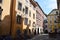 Small square with historic buildings, signs and blue skies in Graz.