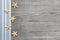 Small starfishes on grey wooden shabby chic background