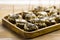 Small starter appetizers with canned fish and cream cheese on wooden tray on table background