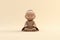 A small statue of a monk sitting on the ground. Generative AI image.