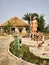 A small statue of Swami Vivekananda with a village hut next to it at a village in Joygopalpur, India- 9th Feb 2018