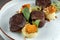 Small steaks garnished with greens. Some mashed potatoes. Macro