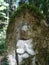 Small stone Jizo statue surrounded by green on the Nakasendo Road hike