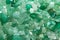 Small stones of green aventurine. Ornamental stone in the form of fine-grained pebbles