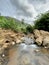 A small stream coming out from a couple of rocks