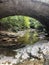 Small stream under stone arch bridge at Indiana state park
