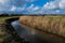 A small stream winds its way through the English countryside