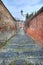 Small street among old walls in Saluzzo, Italy.