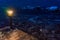 Small streetlight on the edge of a pier in a bay of a winter lake at night