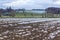 Small strips of snow on plowed fields and meadows.