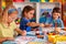 Small students children painting in art school class.