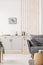 Small studio apartment with contemporary kitchen and grey settee, real photo