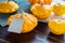 Small summer squash, orange and yellow pumpkins on a wooden table with a craft paper tag, copyspace, autumn farm food