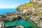 Small swimming lagoon on the rocky coast of the village of Manarola, on the Ligurian coast of Cinque Terre, Italy