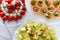 A small table with a delicious buffet of canapes, caviar, sandwiches