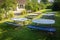 small tables and benches stand on the lawn of a kindergarten