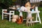 Small tables with many different items on garage sale in yard