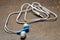 Small tangled blue headphones for a smartphone on a dark background. close-up