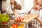 Small teenage girl cutting tomatoes in salad