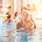 Small teenage girl in hotel resort pool near a bar