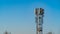 Small telecommunications tower or repeater set against an evening blue sky